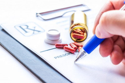 doctor writing prescription receipt